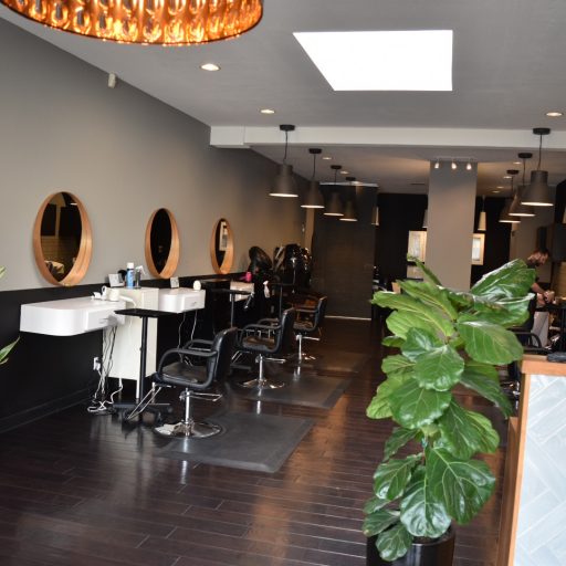 Inside the salon — round mirrors, chairs and the front desk